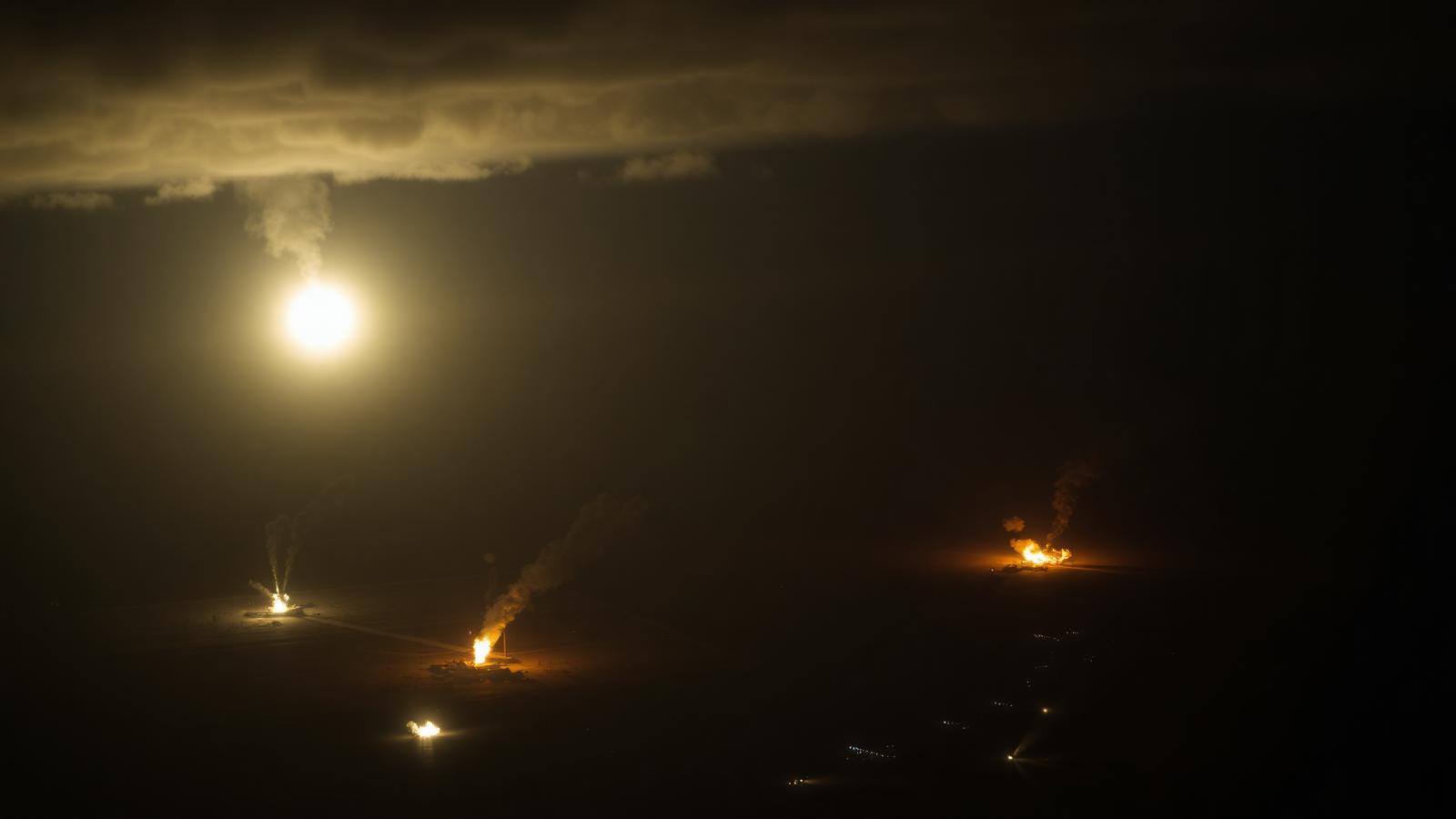 Satellite imagery showing smoke rising over military installations near Tehran
